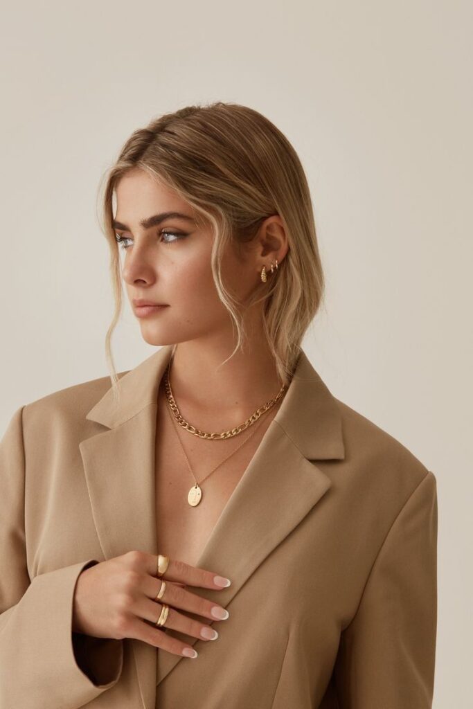 Old Money Style look with a beige blazer and layered gold jewelry for a refined, timeless aesthetic.